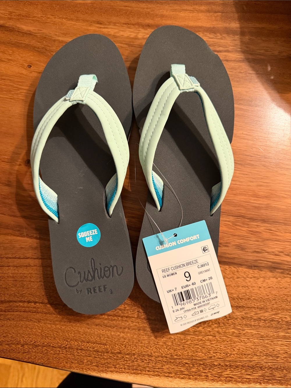 Reef women's flip flops in mint and charcoal with cushioned sole